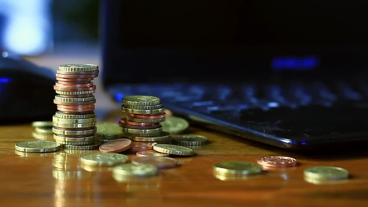 saving coins with money to pay bills having the intention of calculating raising more money to be wealthy stock video stock footage