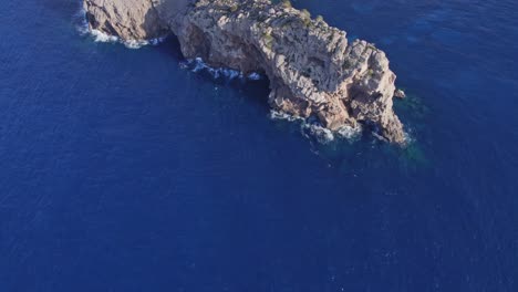 Tilt-up-shot-of-Mirador-de-sa-Foradada-at-Mallorca-island-during-day,-aerial