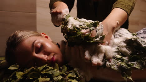 woman receiving a traditional russian banya spa treatment