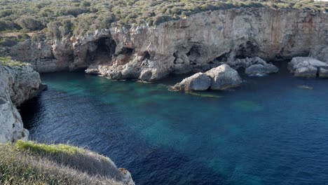 turquoise waters meet rugged cliffs at cala rafalet, baleares, spain, a serene escape