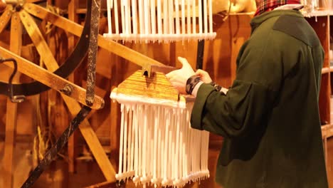 person making candles using traditional methods