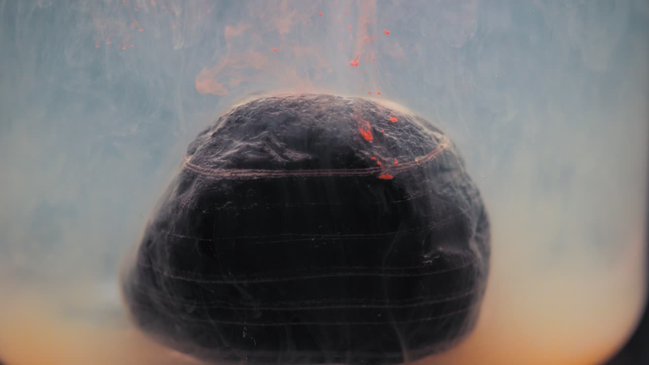 Colored paint floating around beautiful layered rock.  Shot with the Sony a7iii.