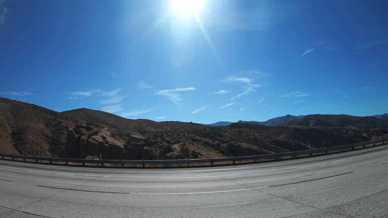 Truck Traveling In The Highways Surrounded With the Green Mountains And Cliffs During Sunny Day - Wide Shot