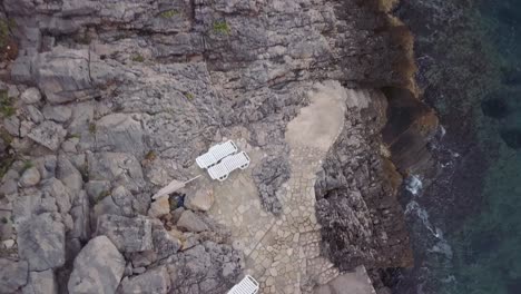 coastal cliff with sunbeds