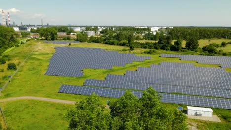 aerial shot above solar panel renewable energy farm outside rural town in poland