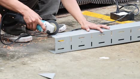 worker cutting metal with sparks flying