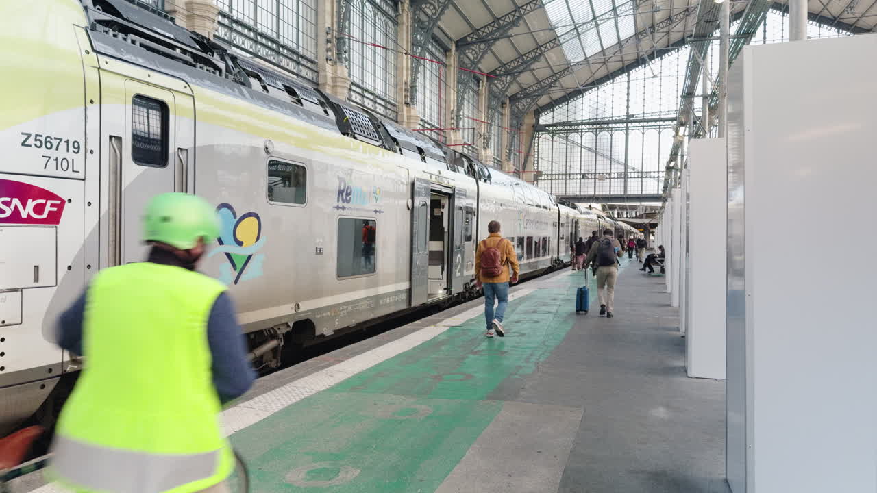 People walk by SNCF train at Gare d’Austerlitz station in Paris, France