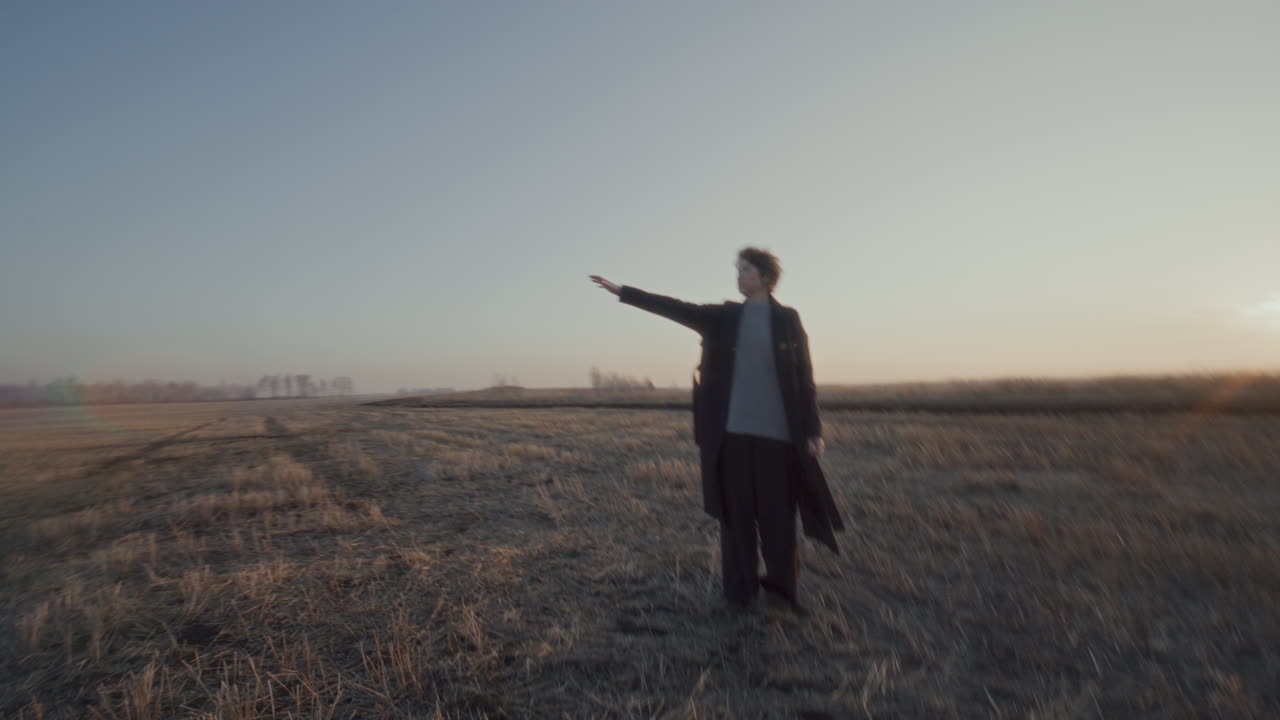 Couple Enjoying Romantic Walk in Open Field during Golden Hour