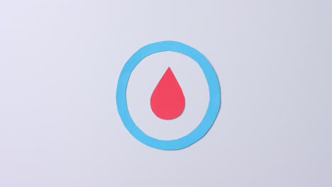 Close-up-of-blood-drop-in-blue-circle-on-white-background,-copy-space,-slow-motion