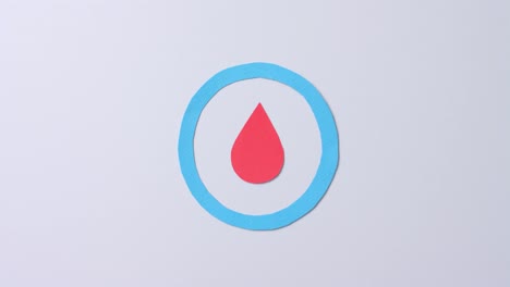 close up of blood drop in blue circle on white background, copy space, slow motion