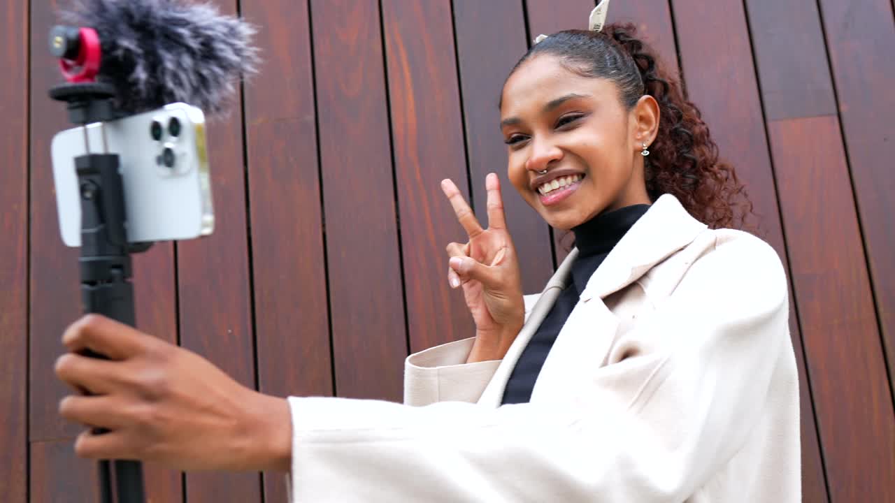 Woman vlogging with smartphone on a tripod