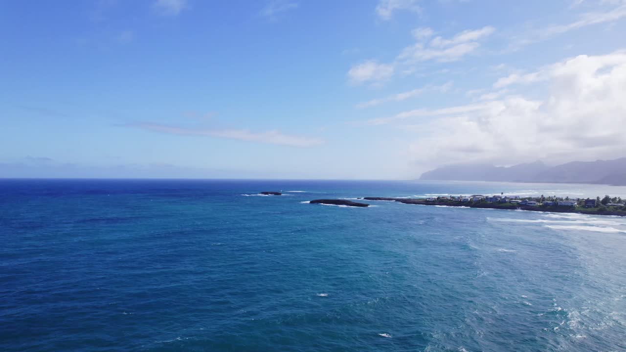Panoramic Coastal View with Blue Ocean and Distant Mountains