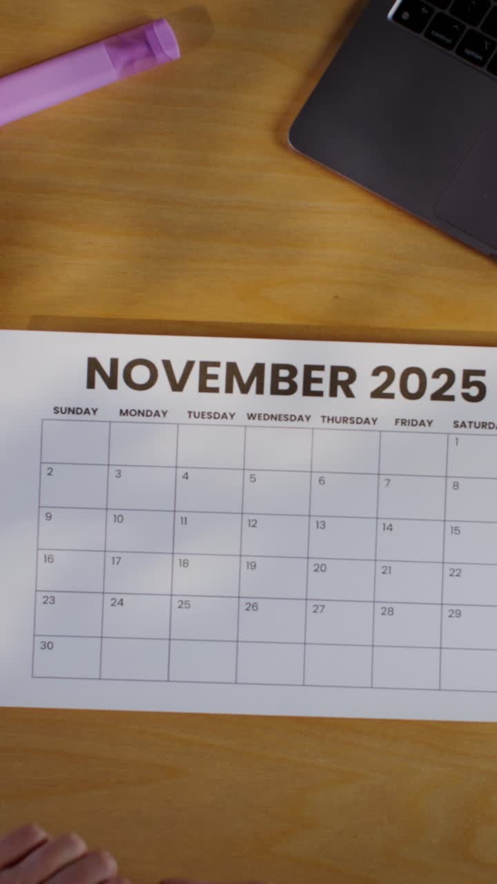 Person marking November 2025 calendar