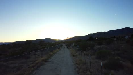 drone flying fast over empty barren wasteland and arid desert landscape