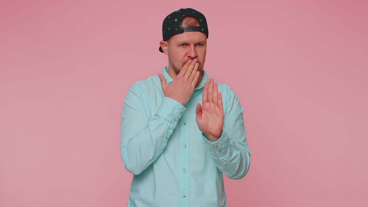 Frightened scared man closing his mouth gestures no refusing to tell terrible secret truth