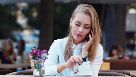 Mujer-Atractiva-Descansa-En-Un-Café-Y-Habla-Por-Teléfono-1