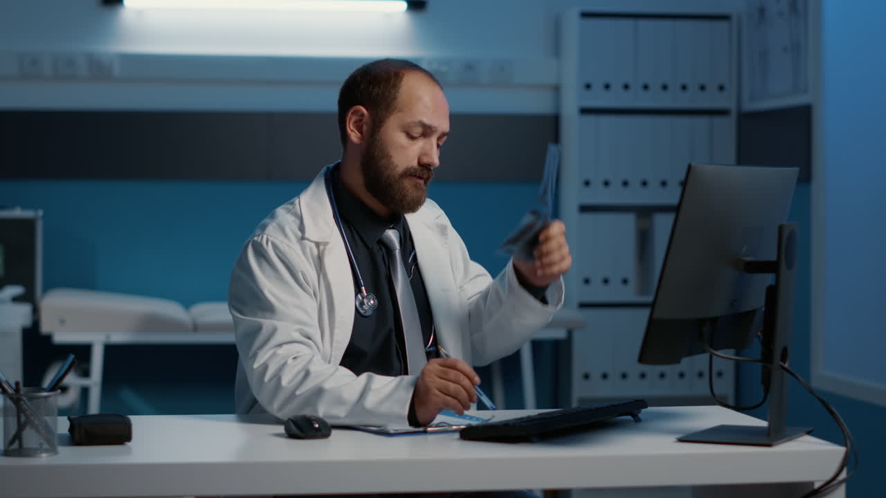 Doctor examining X-ray in office