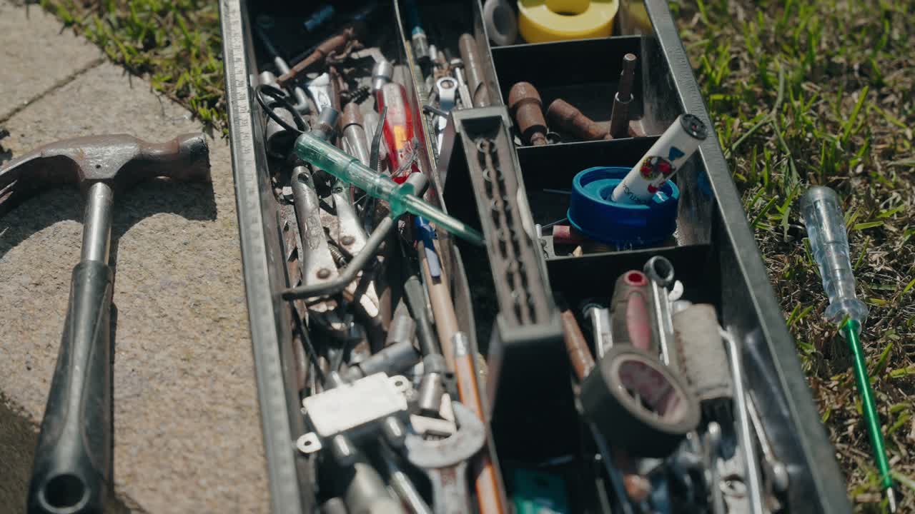 Open toolbox filled with screwdrivers sockets and repair tools