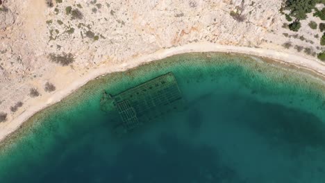 Aerial-Ascending-Of-The-Sunken-German-Ship-By-The-Zavratnica-Canyon-Bay-Near-The-Village-Of-Jablanac,-Croatia