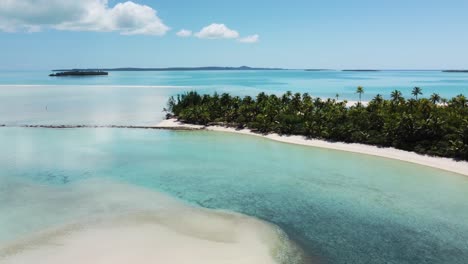 tropical island with lagoon and clear water with white sand beaches and palm trees