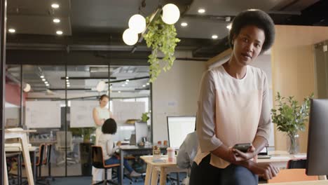 portrait of happy african american casual businesswoman at office, copy space, slow motion