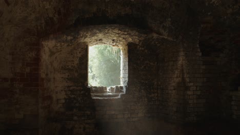 sunlight streaming through a window in an old brick building