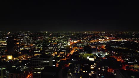 aerial flyover illuminated city of perth with skyline at night in australia