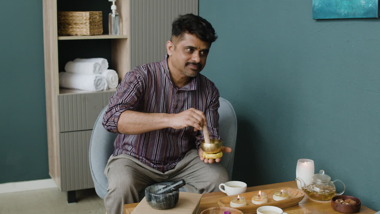 Man using a singing bowl for relaxation