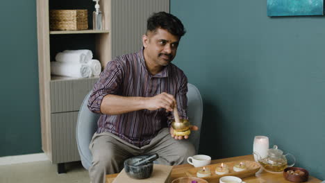 man using a singing bowl for relaxation