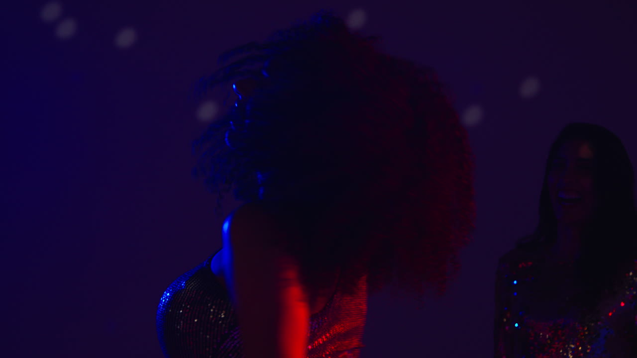 Close Up Of Two Women In Nightclub Bar Or Disco Dancing Talking And Having Fun Together 4