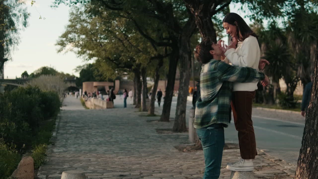 Couple Shares a Kiss in Seville Park