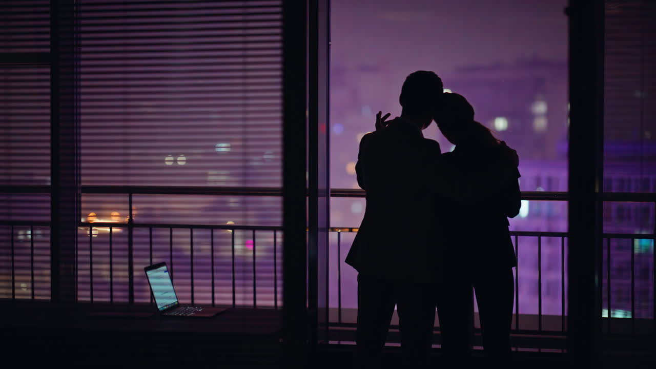 Love couple dark silhouettes looking cityscape rear view. Unknown romantic pair