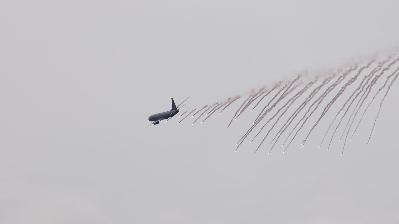A P-8A Poseidon performs a flare drop maneuver in overcast skies at the Avalon Airshow in Geelong, Australia