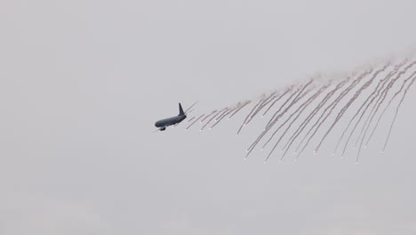 a p-8a poseidon performs a flare drop maneuver in overcast skies at the avalon airshow in geelong, australia