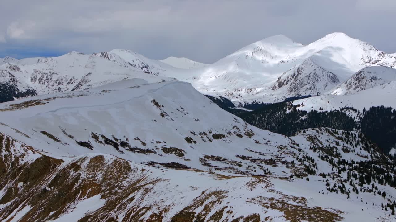 Snow covered Grays and Torreys Peak aerial drone Colorado Montezuma Deer Creek deep backcountry powder winter spring sunny clouds Rocky Mountain White River National Forest zoom in motion