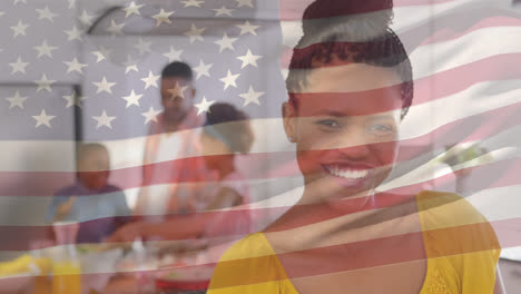 Mixed-race-family-smiling-with-US-flag-waving-foreground