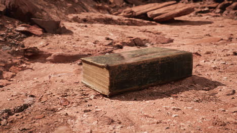 old book in red rock desert