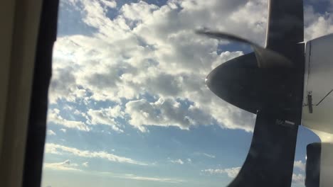 Travel-in-propeller-aircraft-looking-out-at-clouds-and-propeller