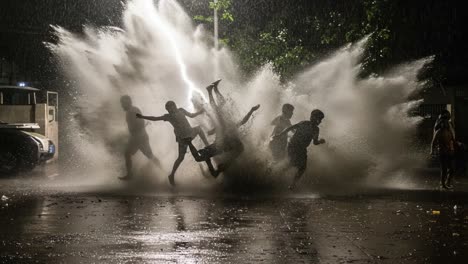 joyful youth embracing adventure in heavy rain, splashes creating a playful atmosphere in the night, evoking laughter and freedom amidst nature's fury