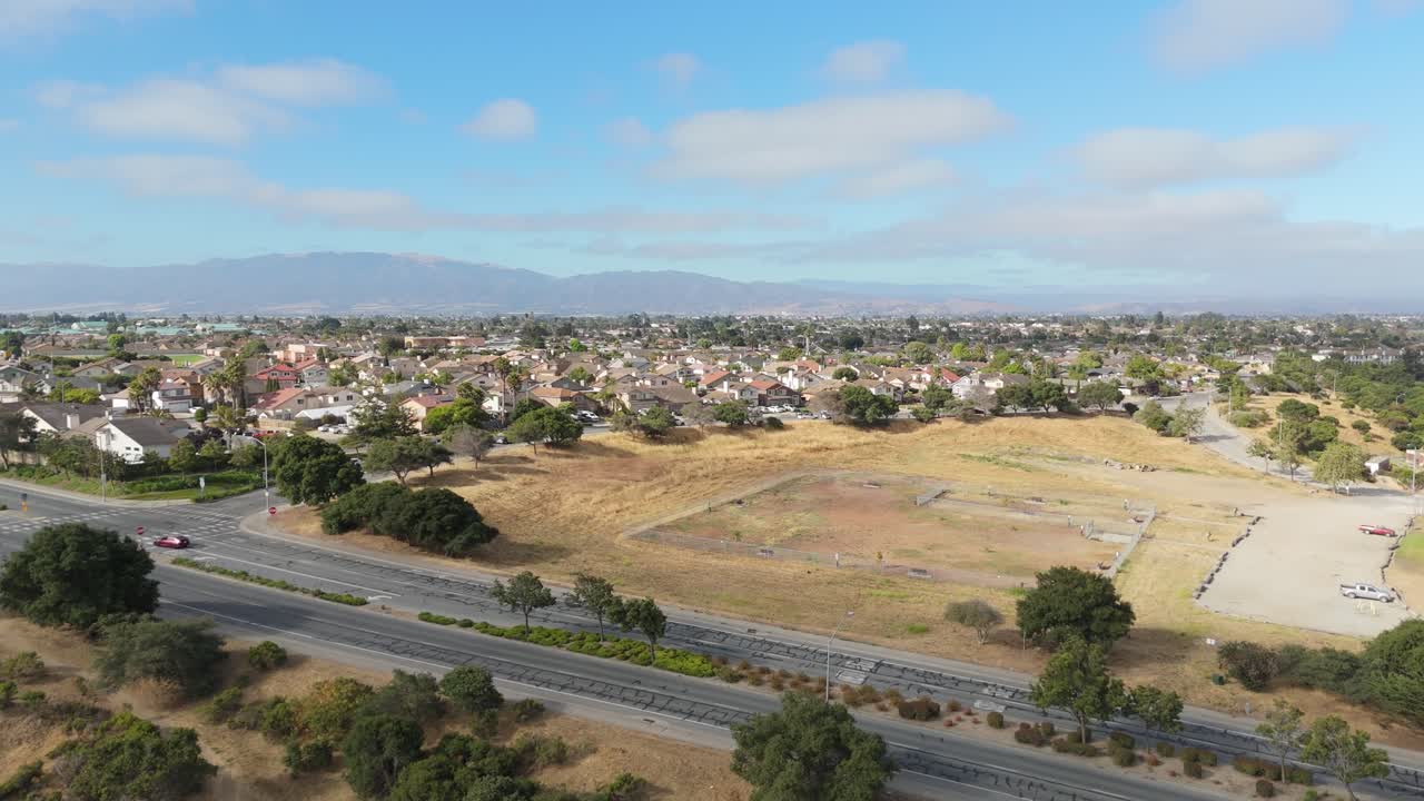 Overhead drone of grassy fields and footpaths curving across Natividad Creek Park, Salinas California