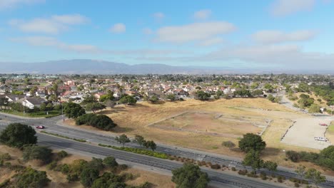 overhead drone of grassy fields and footpaths curving across natividad creek park, salinas california