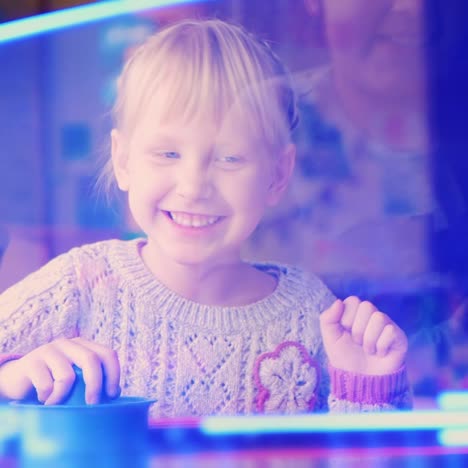 the child enthusiastically plays table hockey