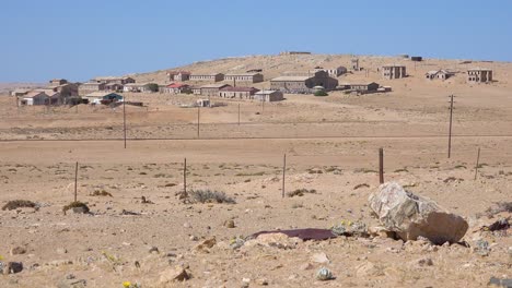 exterior establishing shot of abandoned buildings in the namib desert at the ghost town of kolmanskop namibia 1