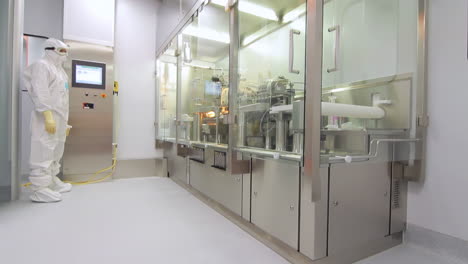 products manufactured include pharmaceutics, semiconductors, and biotechnology. scientist wears protective clothing while being inspected by an inspector, ensuring optimal preservation conditions.