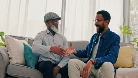 Father,-son-and-fun-handshake-on-sofa