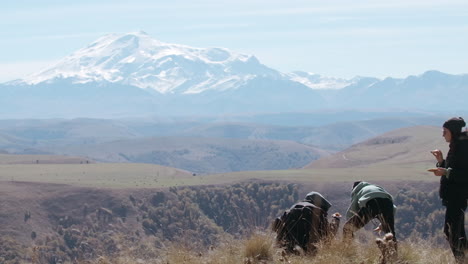 hikers enjoying a scenic mountain view with a picnic