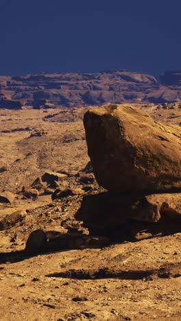 rock formation in a vast desert landscape under a clear blue sky
