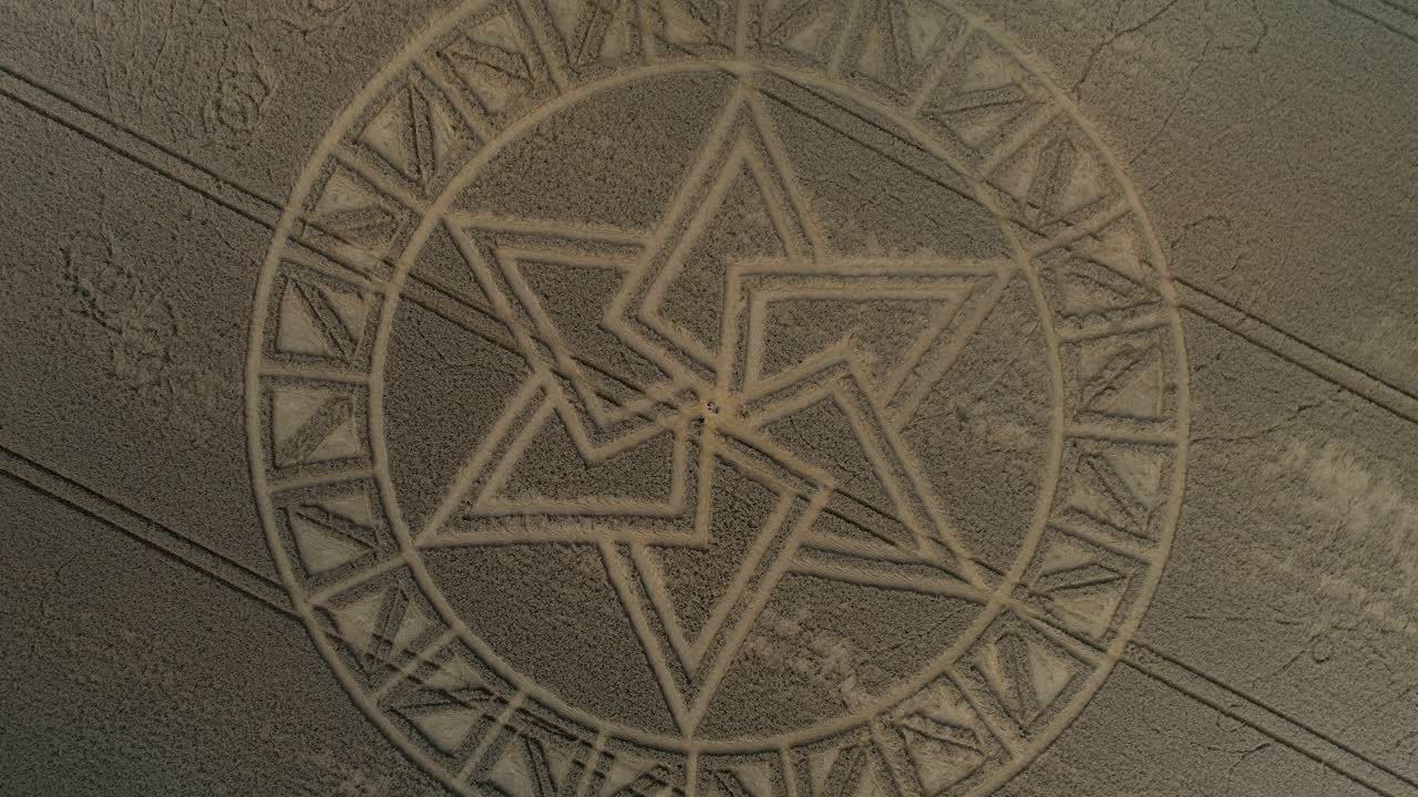 Mysterious detailed West Meon golden barley field crop circle pattern aerial view descending top down