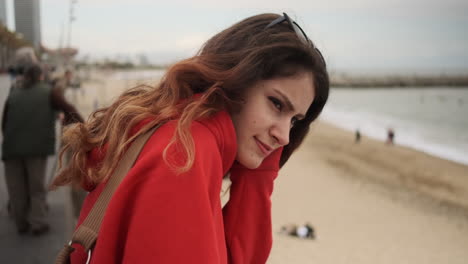 young girl looking at something on the seafront