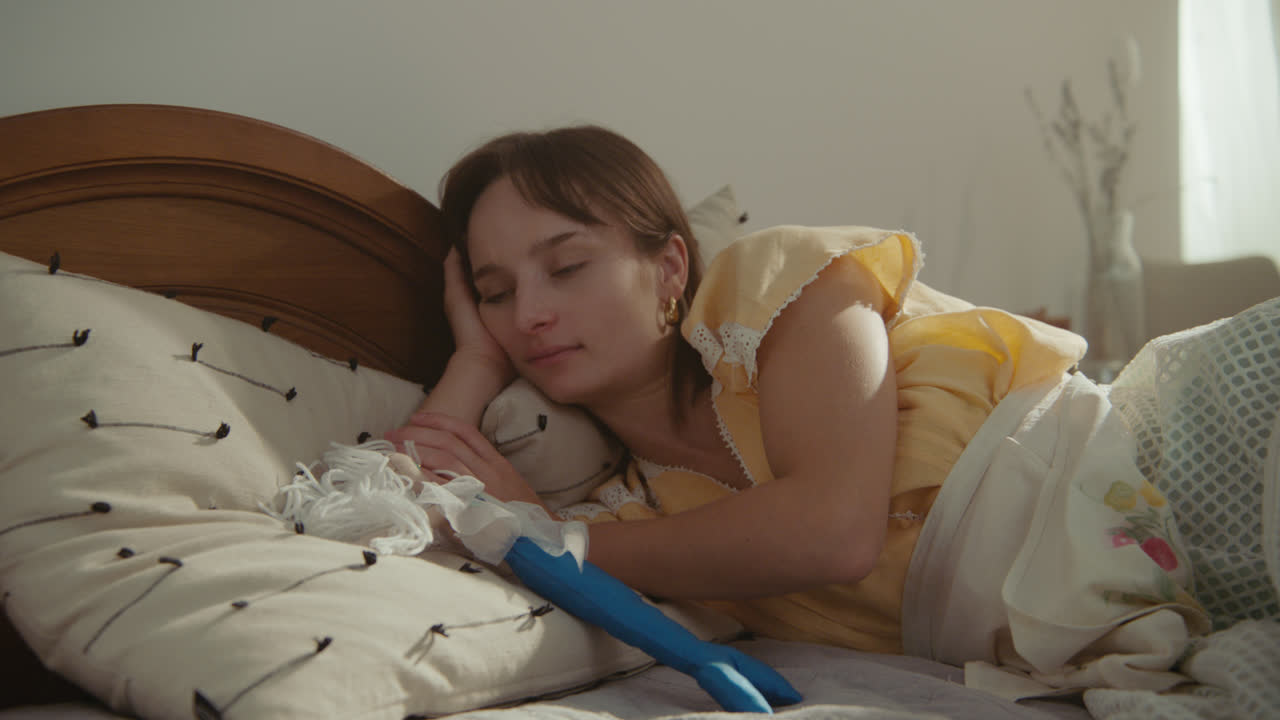 A girl playing with dolls in her room